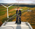 Image:  Engineer standing on wind turbine nacelle